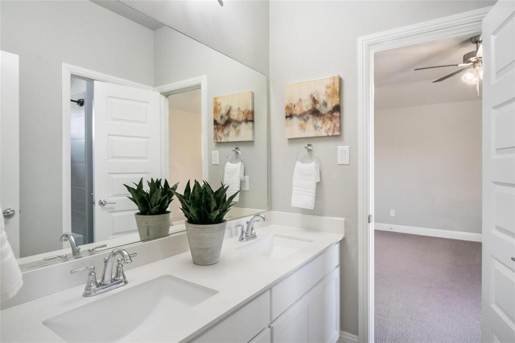 7411 Joshua Road Frisco, TX 75033 - Photo 31 of 40 a bathroom with a sink a potted plant and a mirror