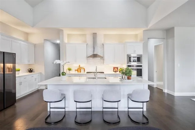 a large kitchen with lots of counter space and windows