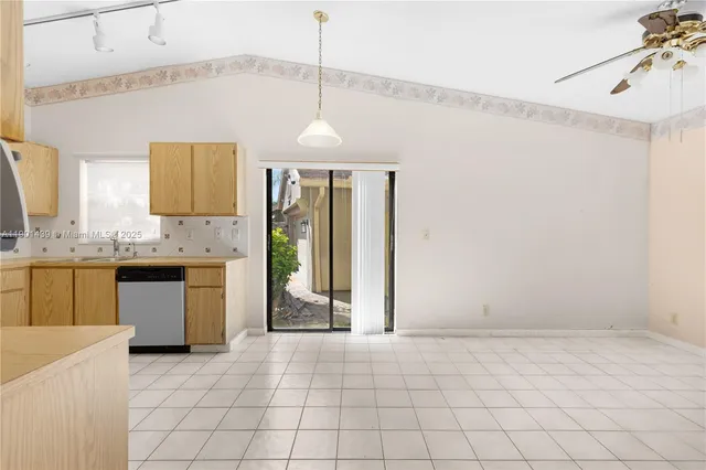 a view of a kitchen with microwave and cabinets