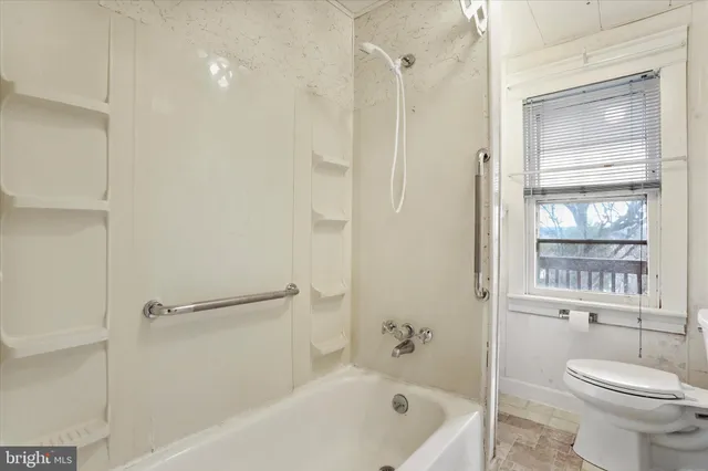 a view of backyard with wooden fence