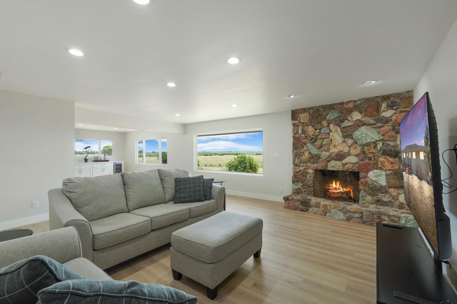 2650 West Twitchell Island Road Rio Vista, CA 94571 - Photo 9 of 60 a living room with furniture a fireplace and a flat screen tv
