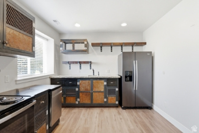 722 West Webb Circle, Unit 2 Draper, UT 84020 - Photo 27 of 39 Kitchen featuring wood-finish flooring, stainless steel refrigerator, dark cabinetry with metal detailing, built-in shelving, and a window with blinds