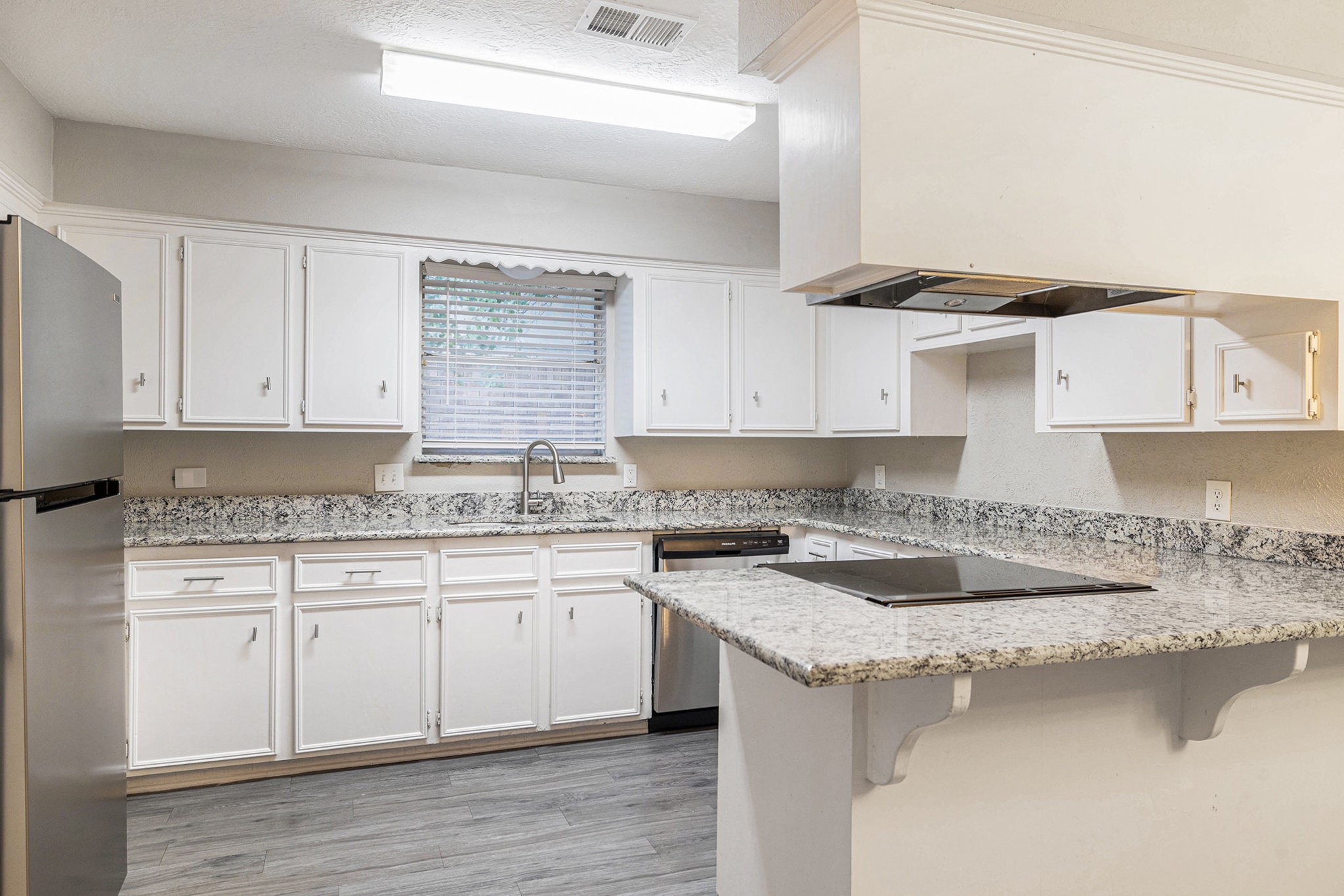 29118 Raestone Street Spring, TX 77386 - Photo 9 of 21 a kitchen with stainless steel appliances granite countertop a sink stove and cabinets