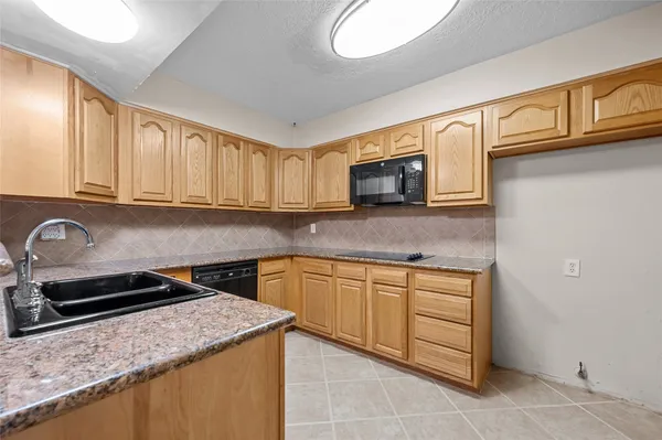 an empty room with a ceiling fan and window