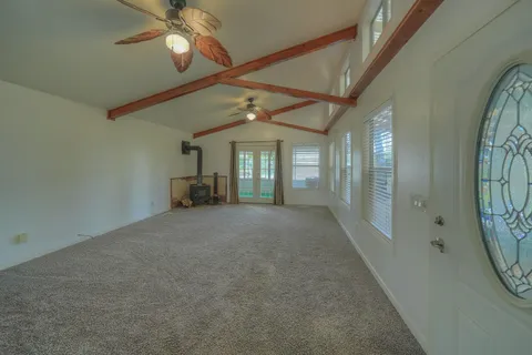 a view of a livingroom with furniture and chandelier fan