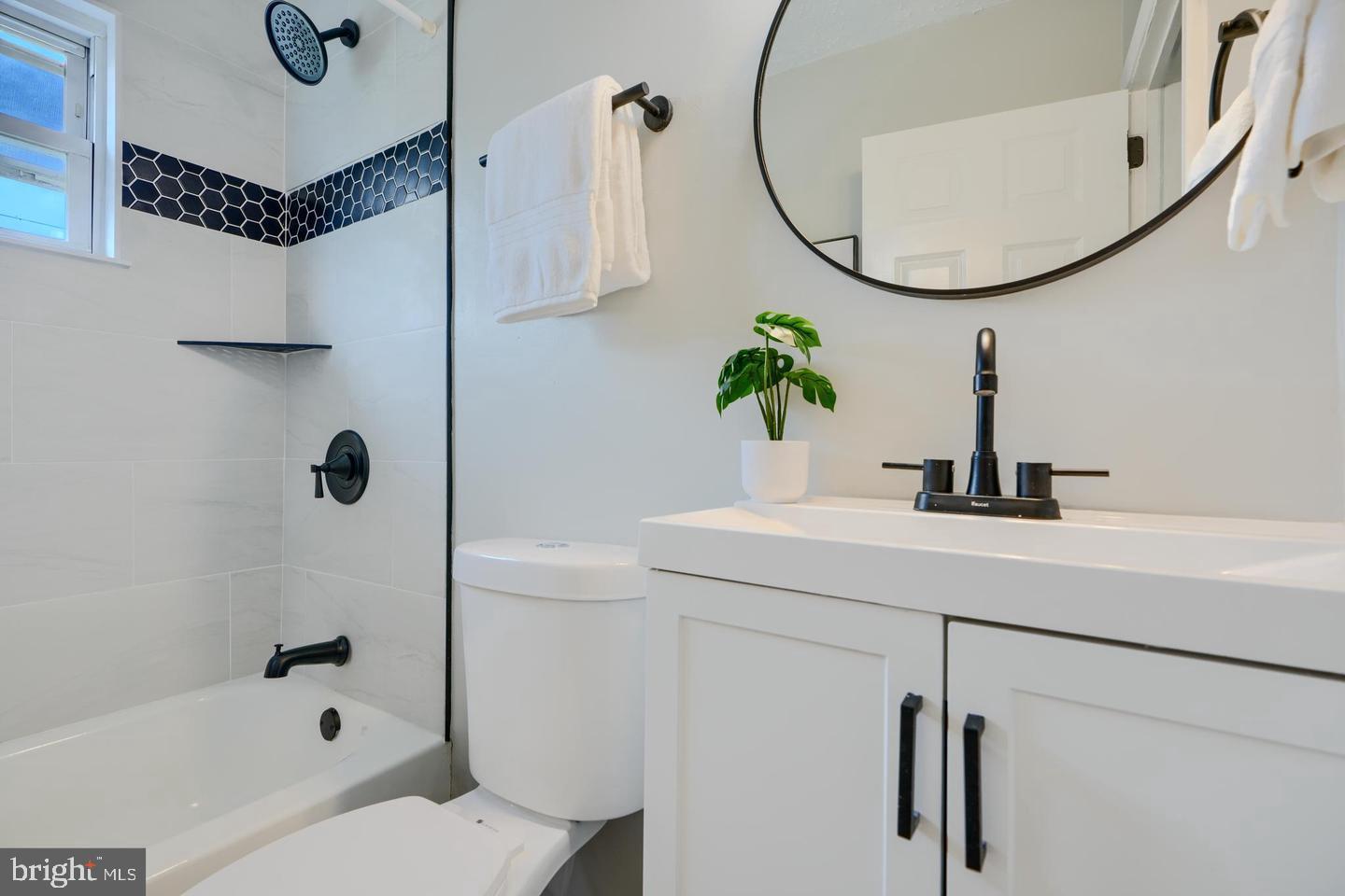1944 Quentin Road Dundalk, MD 21222 - Photo 15 of 41 a bathroom with a sink a toilet and a mirror