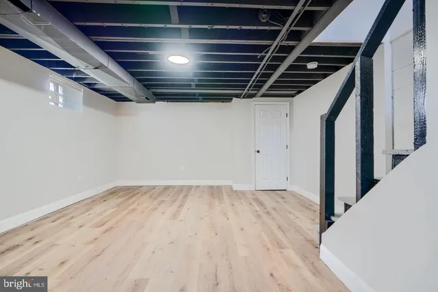 a view of hallway with wooden floor