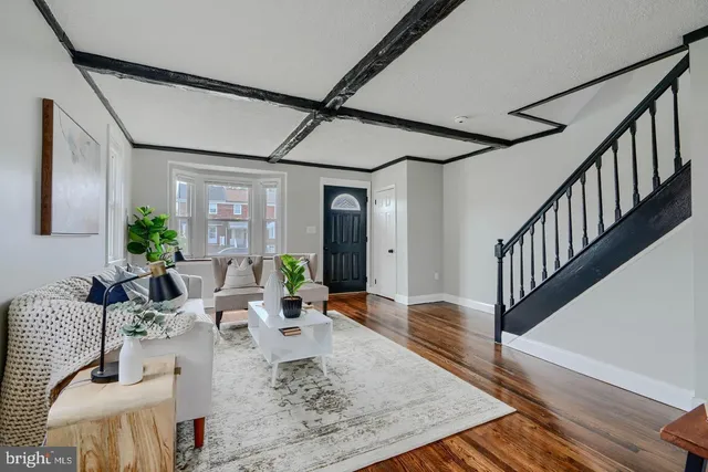 a living room with furniture wooden floor and a chandelier