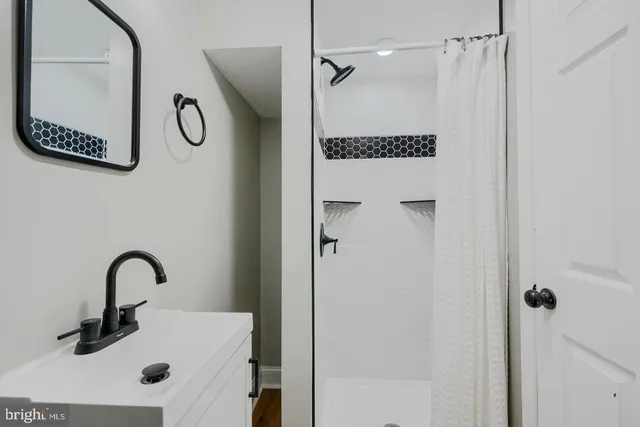 a bathroom with a shower and mirror