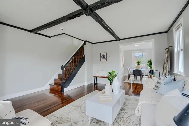 a living room with couches and coffee table with wooden floor