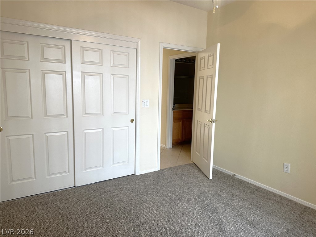 3034 Canal Walk Road Henderson, NV 89052 - Photo 6 of 24 This spacious bedroom offers ample storage and easy access to a private bathroom.