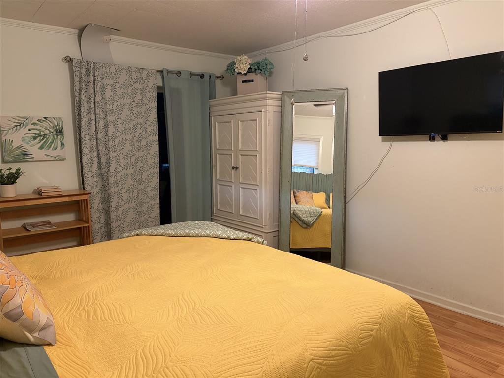 421 Riviera Street Venice, FL 34285 - Photo 12 of 30 a bedroom with a bed and a flat screen tv