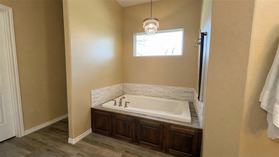 11810 Riley Green Road Franklin, TX 77856 - Photo 17 of 36 a bathroom with a tub sink and vanity