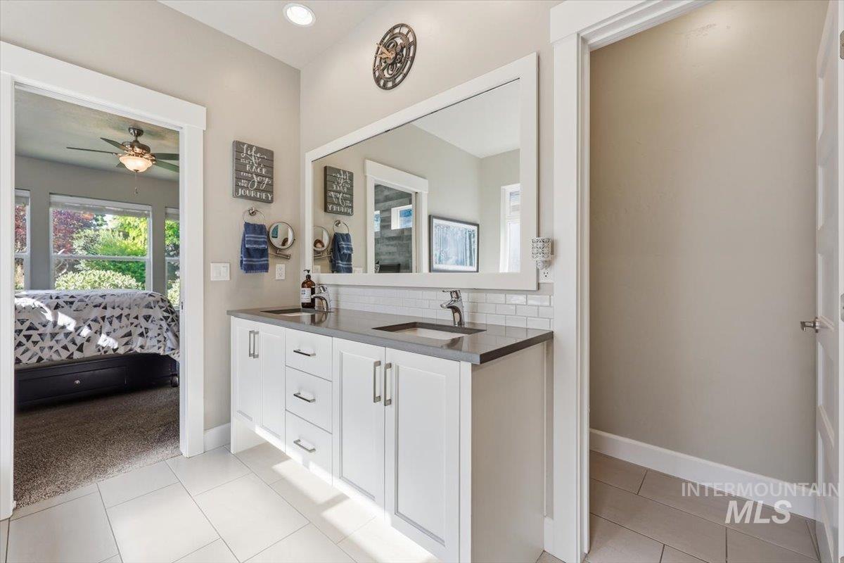 1303 West Brando Street Meridian, ID 83646 - Photo 25 of 49 Double vanity with a dark countertop and undermount sinks