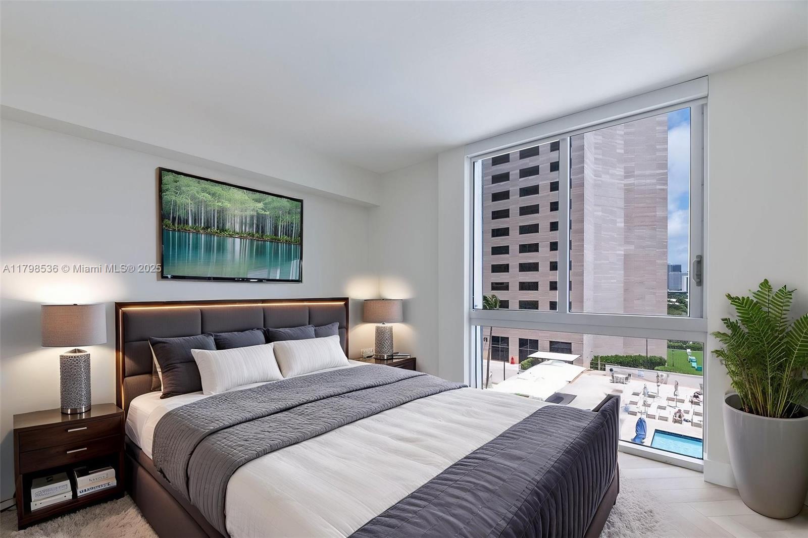 335 South Biscayne Boulevard, Unit 1012 Miami, FL 33131 - Photo 2 of 14 a bedroom with bed and a window