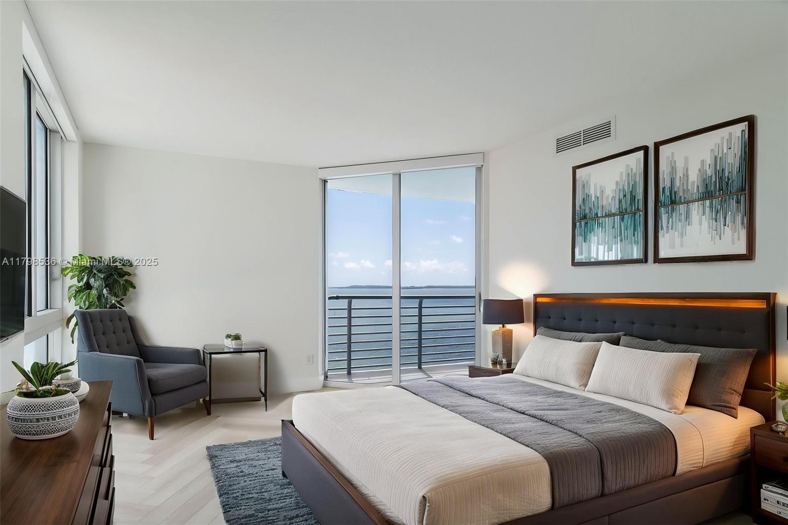 335 South Biscayne Boulevard, Unit 1012 Miami, FL 33131 - Photo 4 of 14 a bedroom with a bed a couch and a potted plant