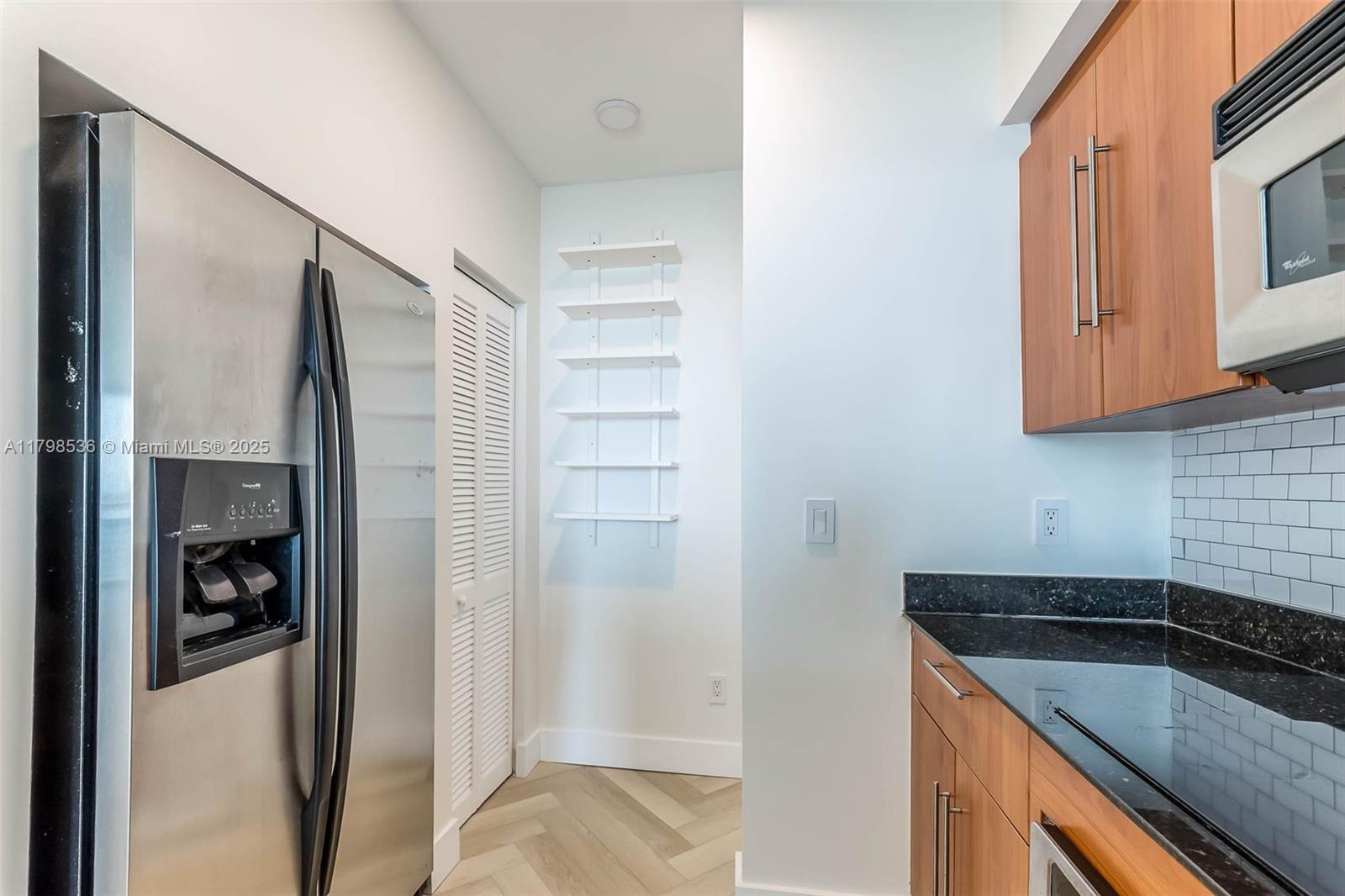 335 South Biscayne Boulevard, Unit 1012 Miami, FL 33131 - Photo 8 of 14 a kitchen with a refrigerator and a stove top oven