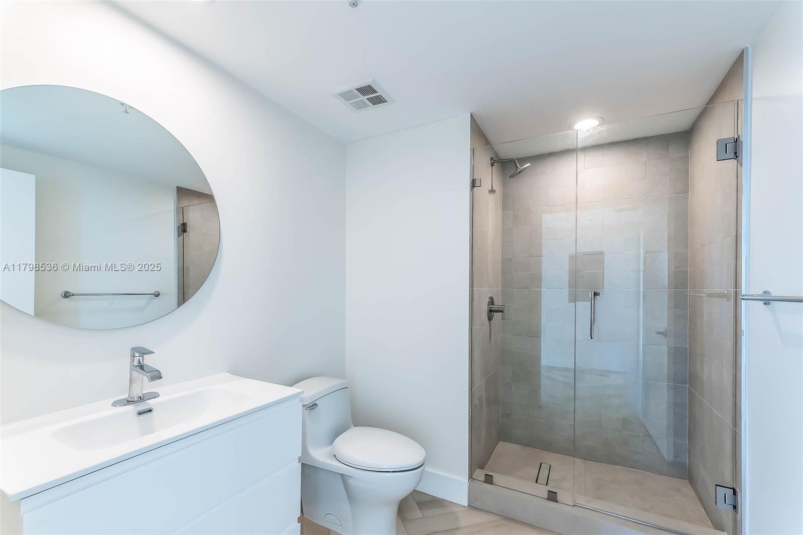 335 South Biscayne Boulevard, Unit 1012 Miami, FL 33131 - Photo 9 of 14 a bathroom with a sink mirror toilet and shower