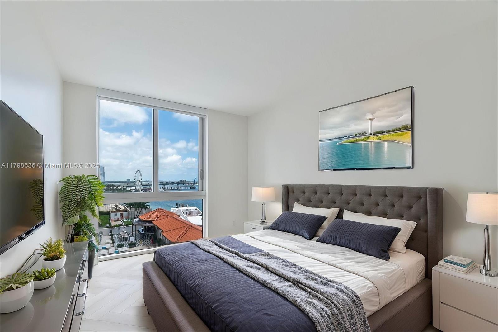335 South Biscayne Boulevard, Unit 1012 Miami, FL 33131 - Photo 10 of 14 a bedroom with a bed and large window