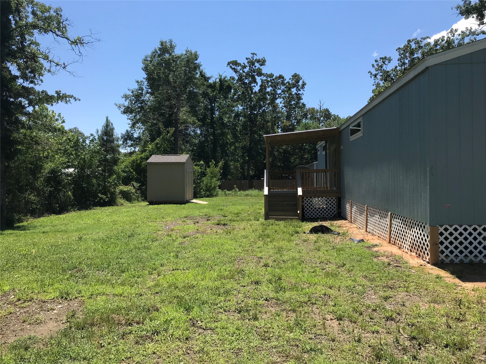 246 Brenda Road Trinity, TX 75862 - Photo 12 of 24 a backyard of a house with lots of green space and outdoor seating