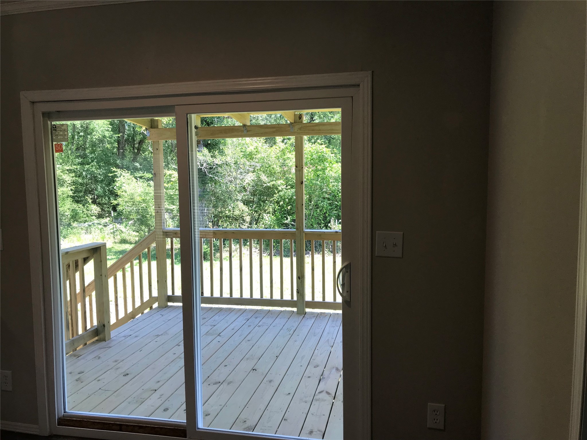 246 Brenda Road Trinity, TX 75862 - Photo 22 of 24 a view of a room with wooden floor and a window