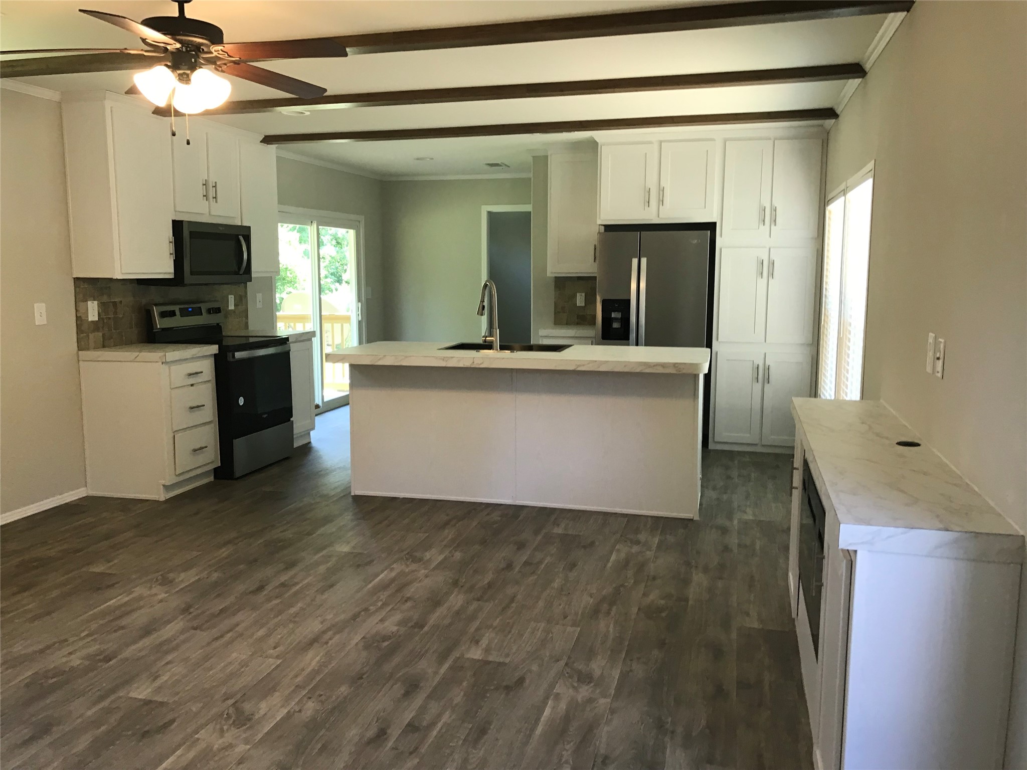 246 Brenda Road Trinity, TX 75862 - Photo 6 of 24 a living room with stainless steel appliances kitchen island granite countertop a refrigerator a stove top oven a sink and dishwasher