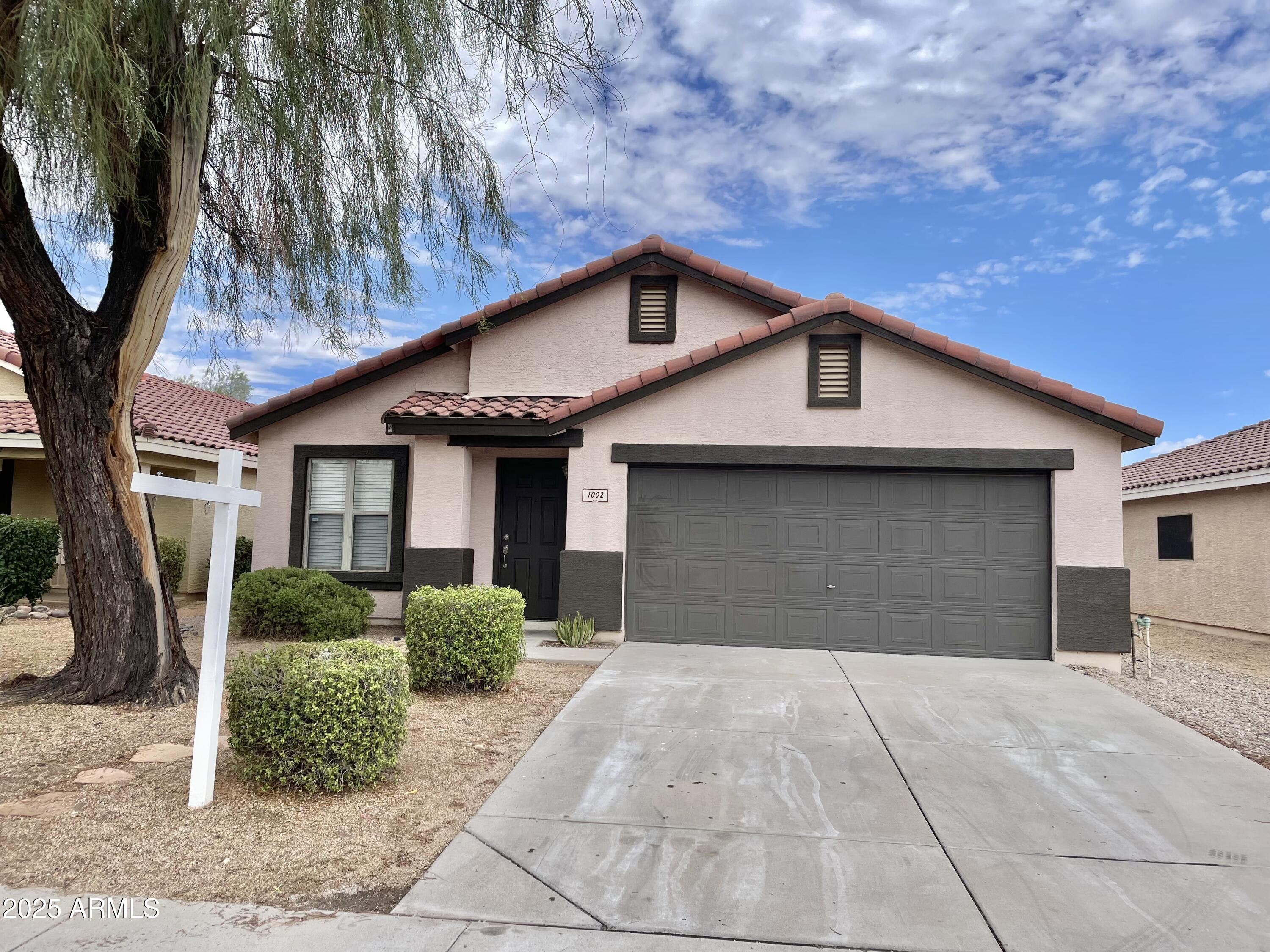 1002 East Arabian Drive Gilbert, AZ 85296 - Photo 2 of 23 a front view of a house with garden