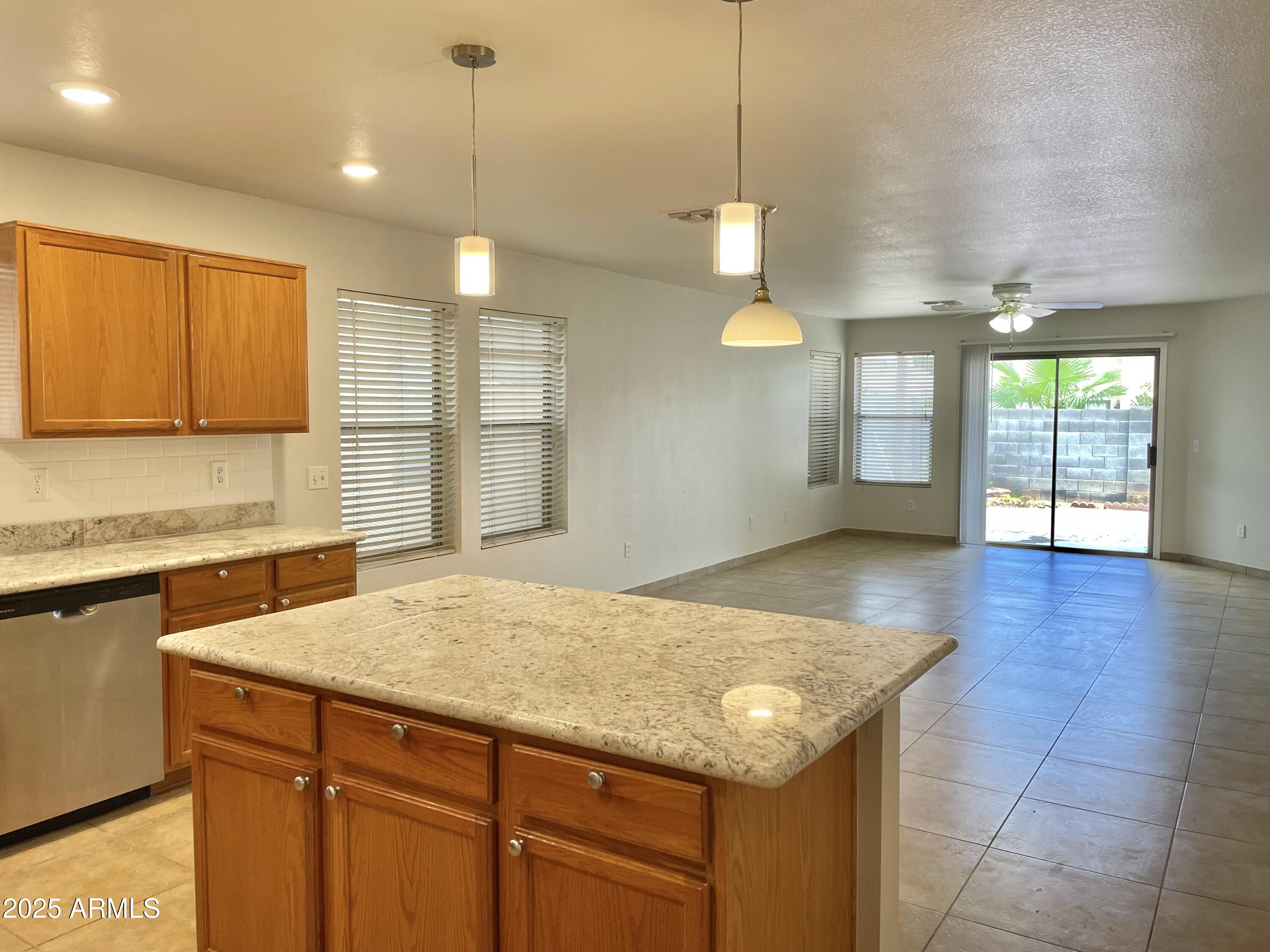 1002 East Arabian Drive Gilbert, AZ 85296 - Photo 10 of 23 a kitchen with a sink chandelier and wooden floor