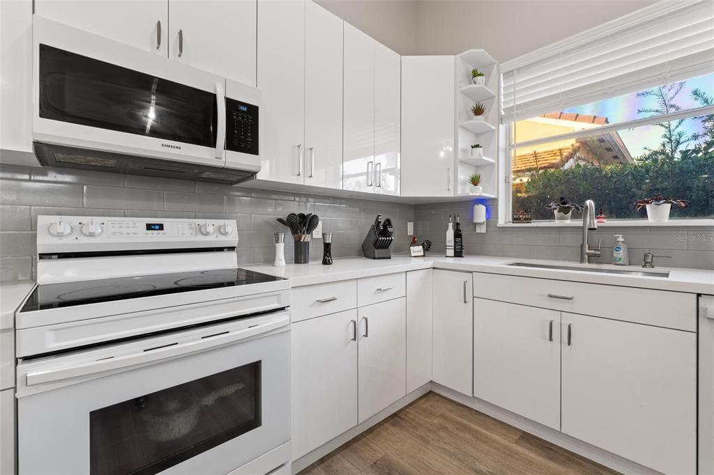 343 Southwest 187th Terrace Pembroke Pines, FL 33029 - Photo 16 of 48 a kitchen with stainless steel appliances white cabinets granite counter tops and a window