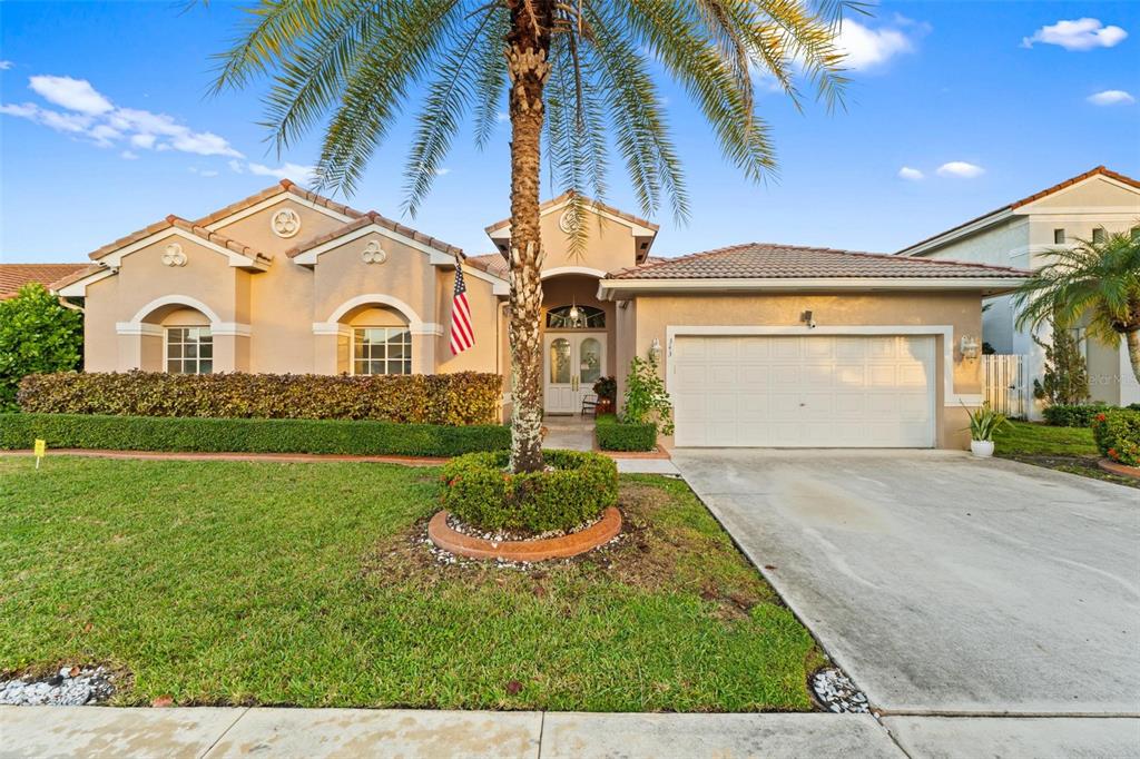 343 Southwest 187th Terrace Pembroke Pines, FL 33029 - Photo 2 of 48 a front view of a house with a yard and garage