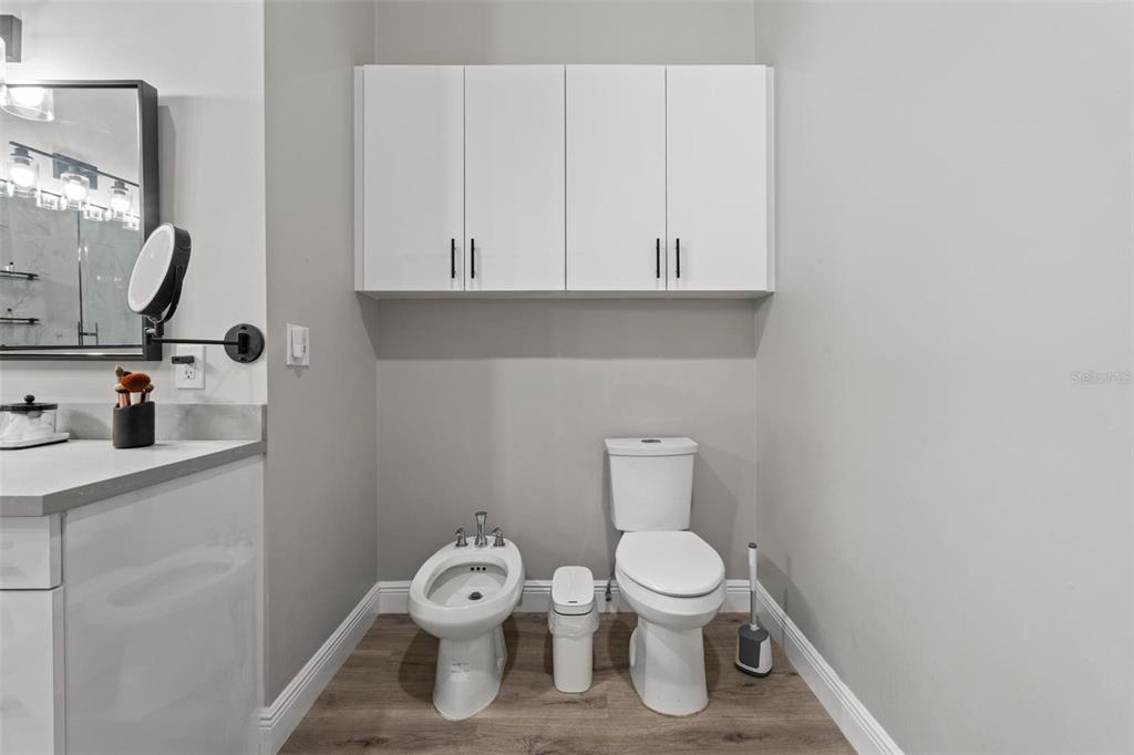 343 Southwest 187th Terrace Pembroke Pines, FL 33029 - Photo 27 of 48 a white toilet sitting next to a bathroom sink