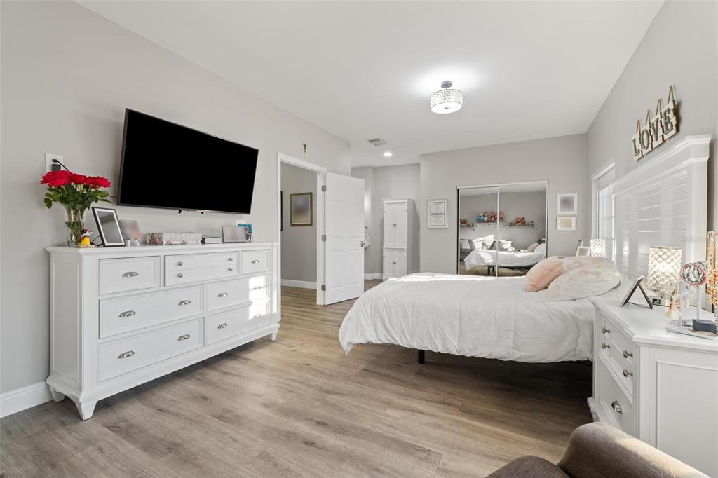 343 Southwest 187th Terrace Pembroke Pines, FL 33029 - Photo 29 of 48 a bedroom with a large bed and a flat tv screen on dresser