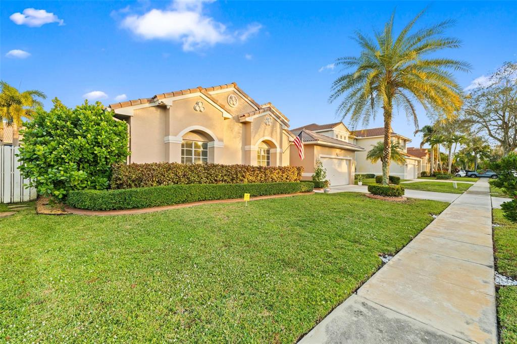 343 Southwest 187th Terrace Pembroke Pines, FL 33029 - Photo 3 of 48 a front view of a house with a garden