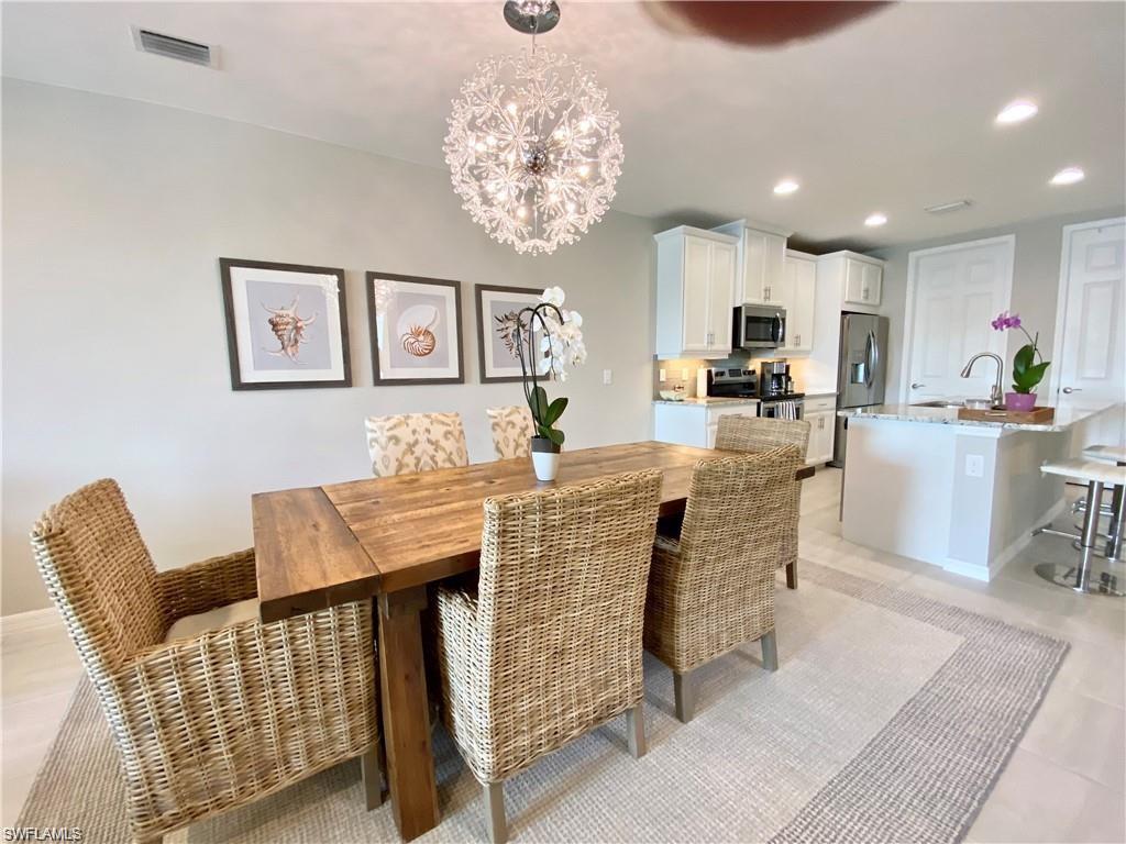14827 Edgewater Circle Naples, FL 34114 - Photo 11 of 32 a dining room with furniture and window