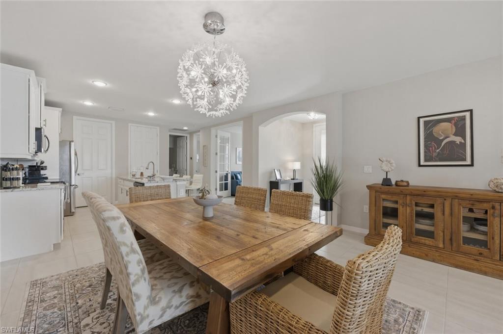 14827 Edgewater Circle Naples, FL 34114 - Photo 12 of 49 a view of a dining room with furniture