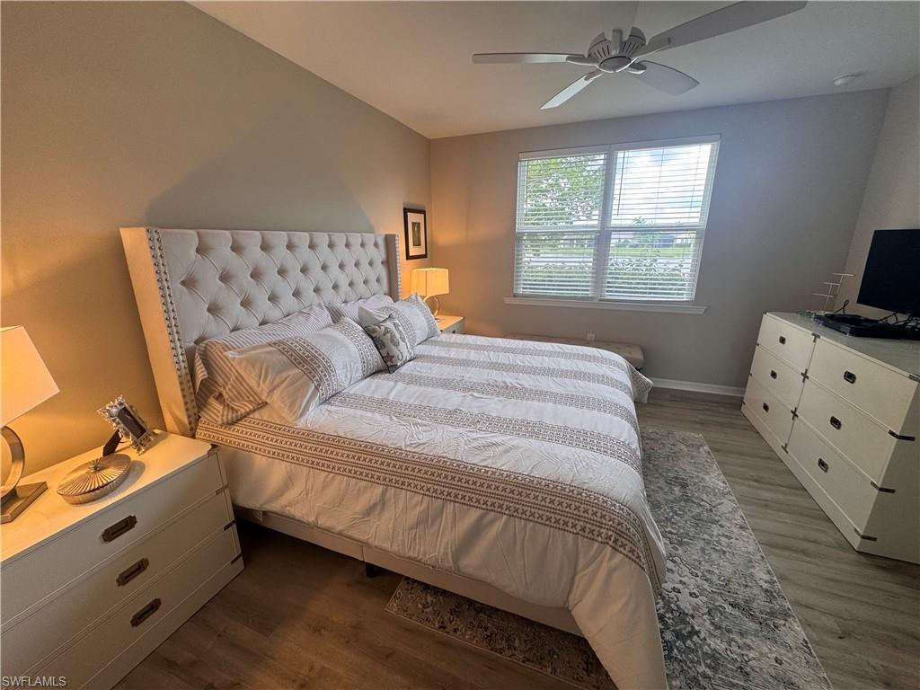 14827 Edgewater Circle Naples, FL 34114 - Photo 14 of 32 a bedroom with a bed and a window