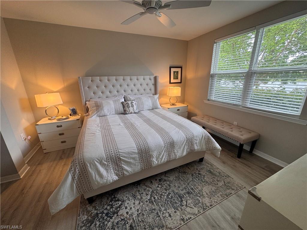 14827 Edgewater Circle Naples, FL 34114 - Photo 15 of 32 a bedroom with a bed and window