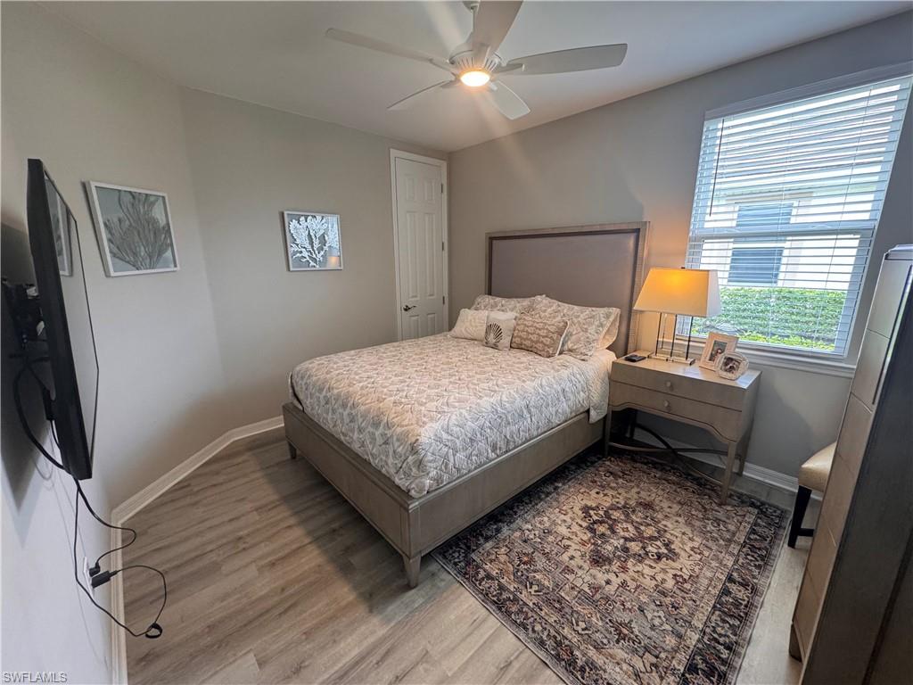 14827 Edgewater Circle Naples, FL 34114 - Photo 17 of 32 a bedroom with a bed wall painting and a window