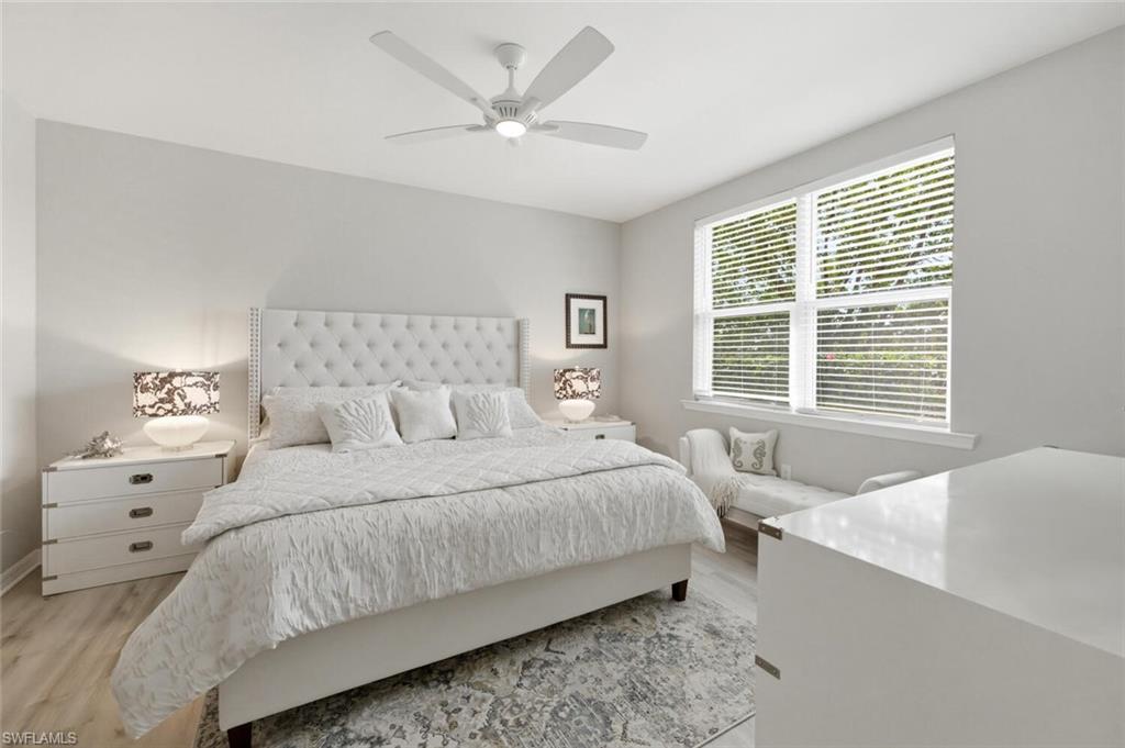 14827 Edgewater Circle Naples, FL 34114 - Photo 21 of 49 a bedroom with a large bed and a window