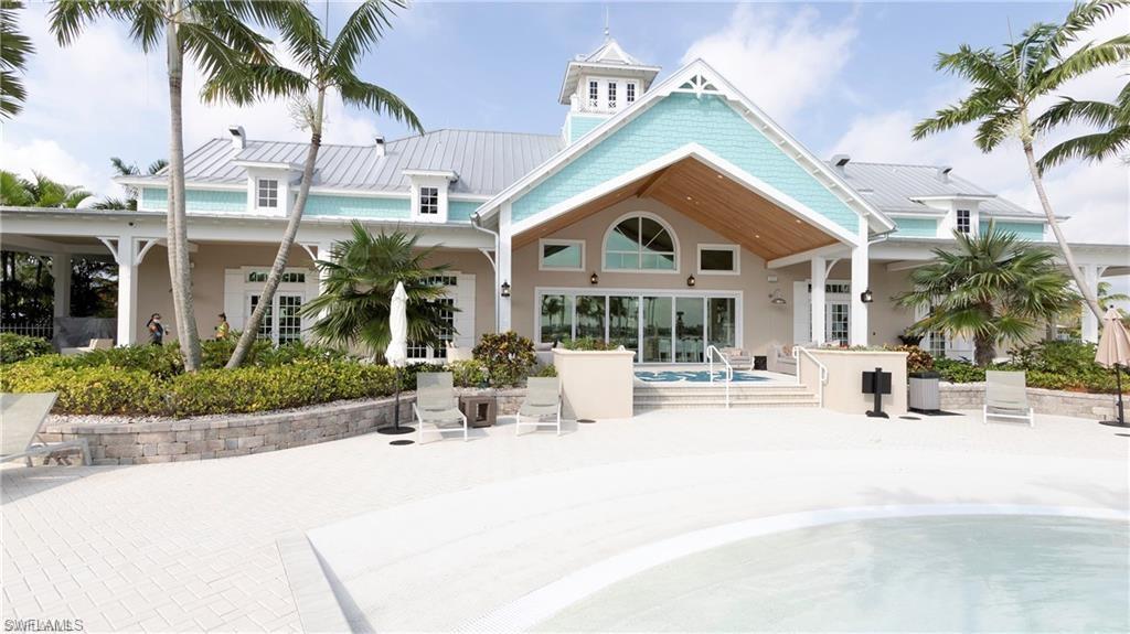 14827 Edgewater Circle Naples, FL 34114 - Photo 21 of 32 a view of house with yard and tree in front of it