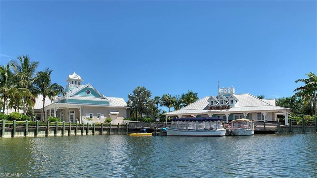 14827 Edgewater Circle Naples, FL 34114 - Photo 22 of 32 a view of a house with swimming pool and chairs