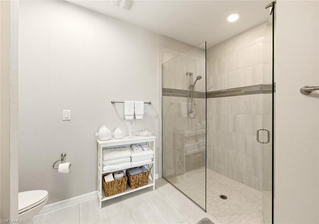 14827 Edgewater Circle Naples, FL 34114 - Photo 24 of 49 a bathroom with a shower a toilet and a sink