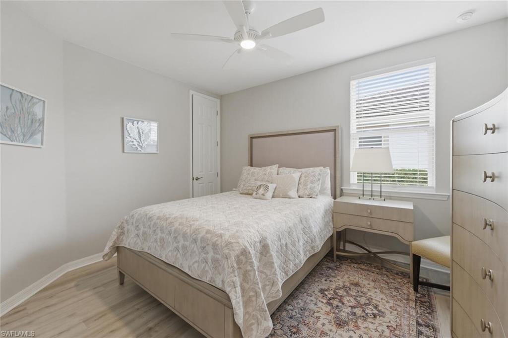 14827 Edgewater Circle Naples, FL 34114 - Photo 25 of 49 a bedroom with a bed and a window