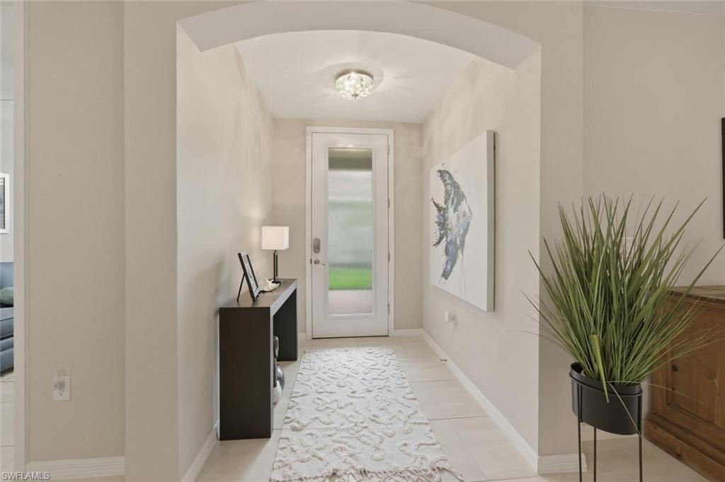 14827 Edgewater Circle Naples, FL 34114 - Photo 28 of 49 a hallway with a washer and dryer