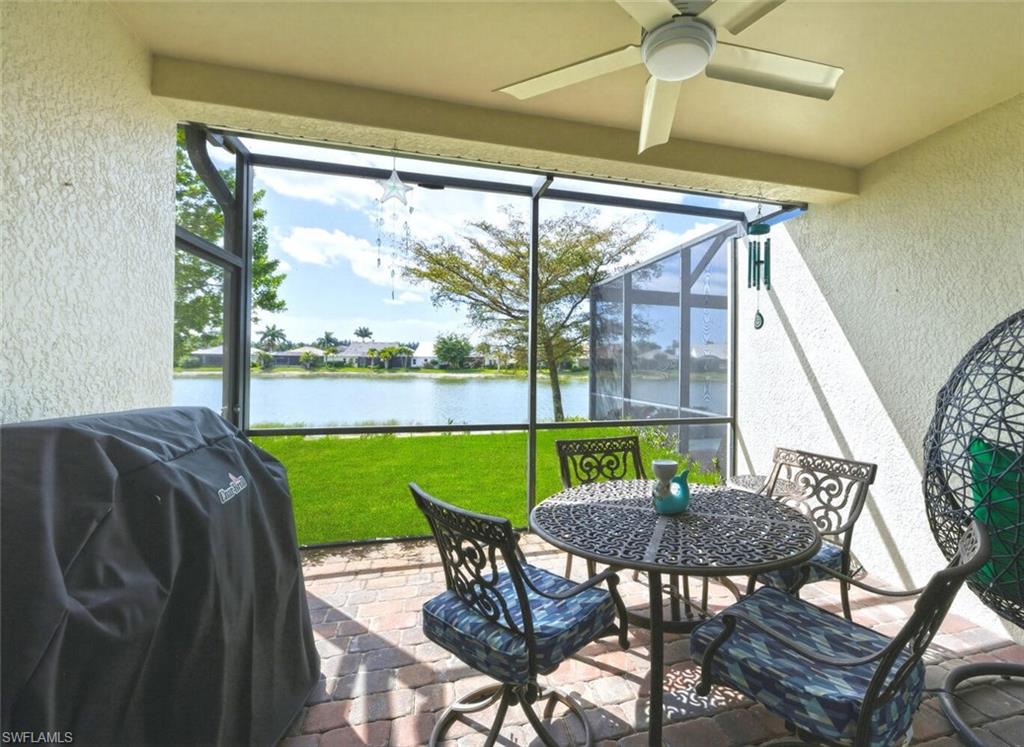 14827 Edgewater Circle Naples, FL 34114 - Photo 29 of 49 a view of a porch with furniture and a yard