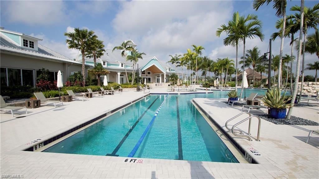 14827 Edgewater Circle Naples, FL 34114 - Photo 3 of 32 a swimming pool with outdoor seating and yard