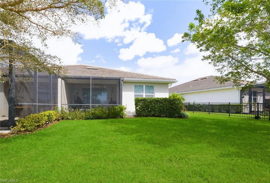 14827 Edgewater Circle Naples, FL 34114 - Photo 31 of 49 a view of a house with a large garden and a large tree