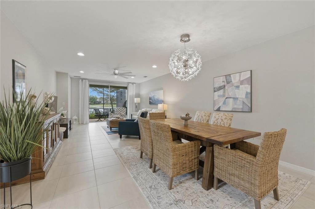 14827 Edgewater Circle Naples, FL 34114 - Photo 4 of 49 a view of a dining room with furniture and chandelier