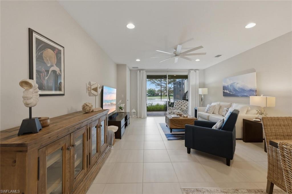14827 Edgewater Circle Naples, FL 34114 - Photo 5 of 49 a living room with furniture and a large window