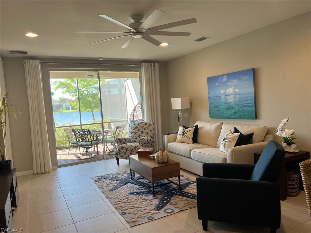 14827 Edgewater Circle Naples, FL 34114 - Photo 6 of 32 a living room with furniture and a large window